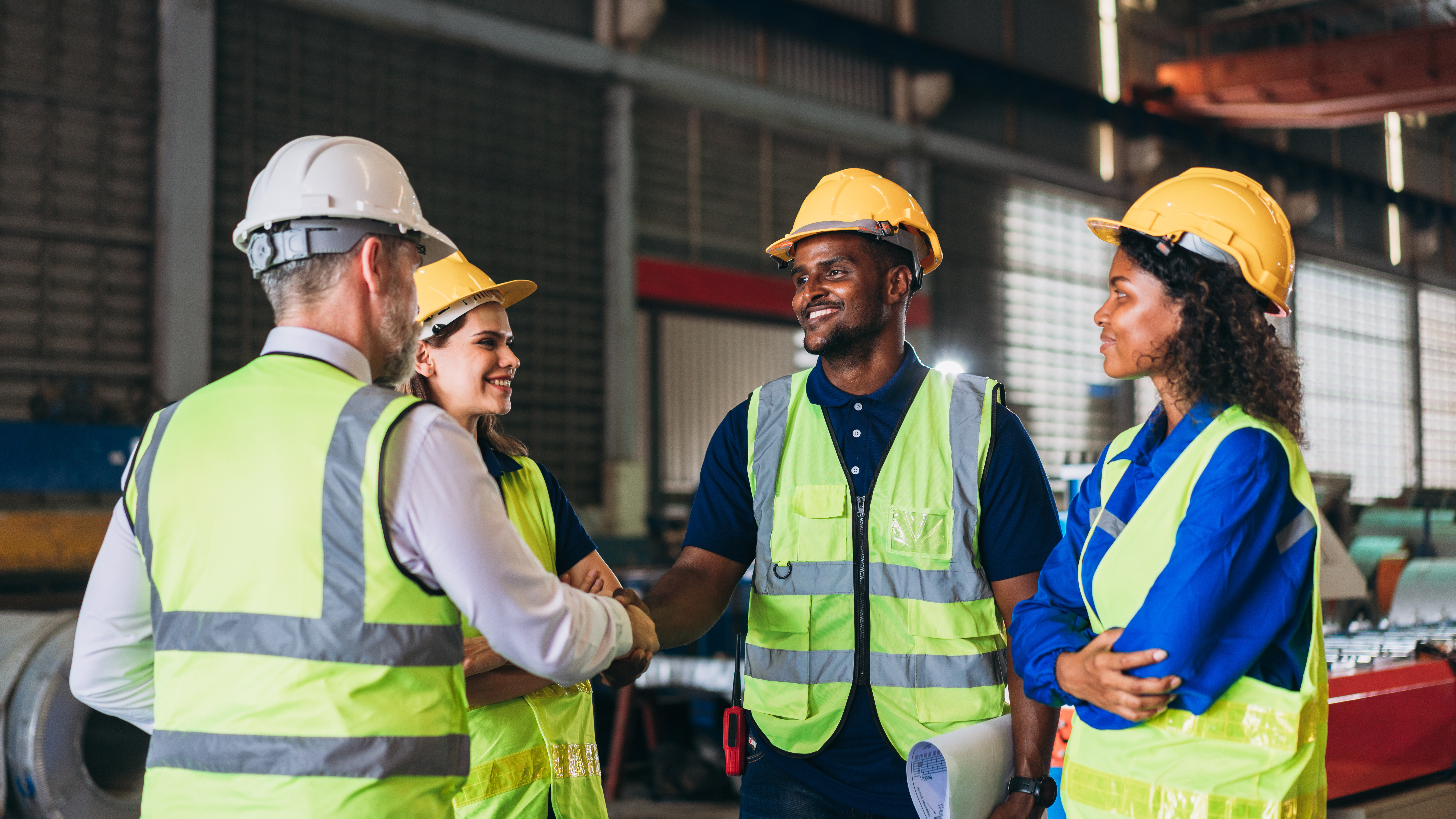 A group of workers engaging in conversation, showing signs of partnership and agreement