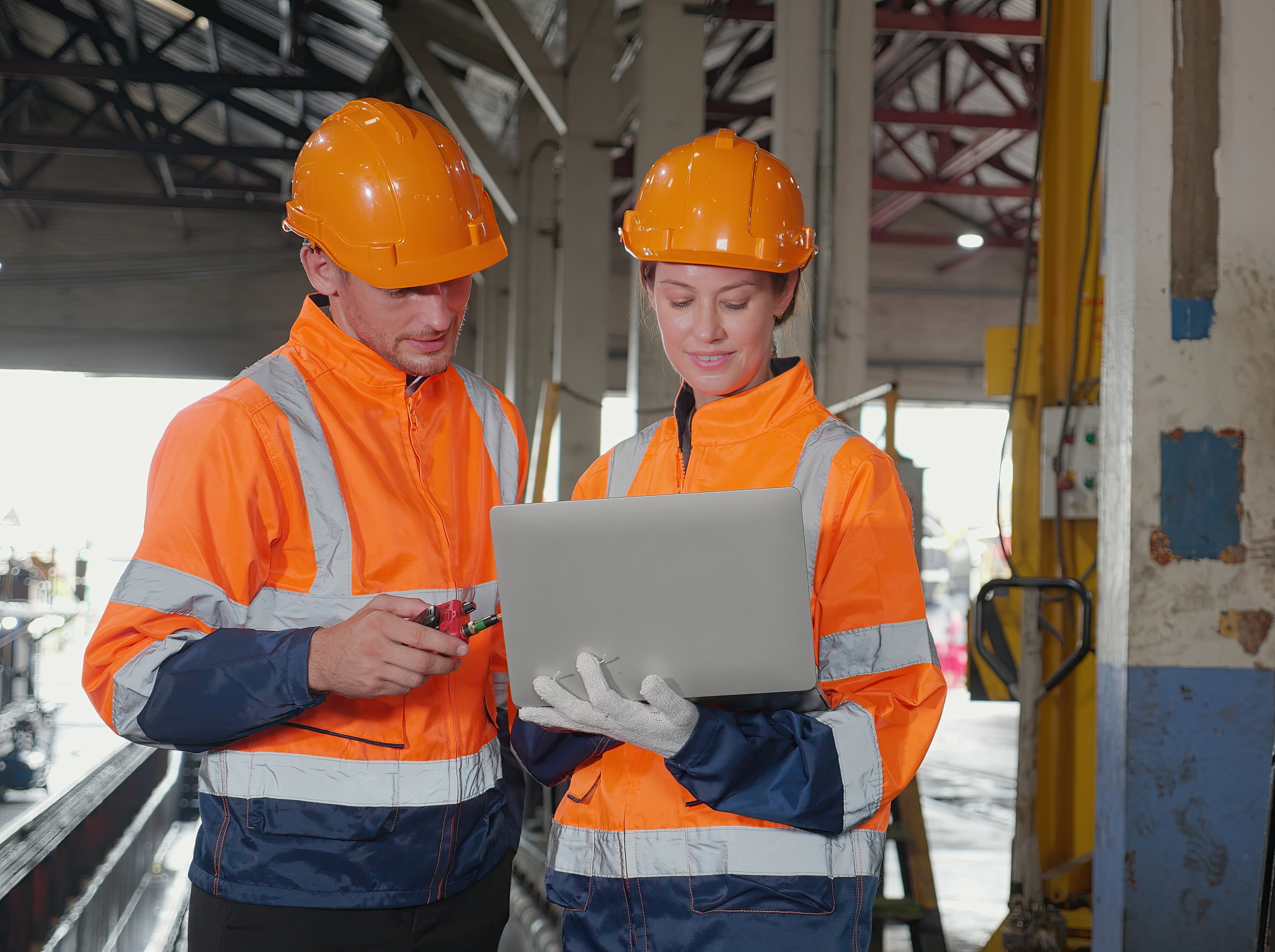 Two people view computer plans for rail maintenance prep